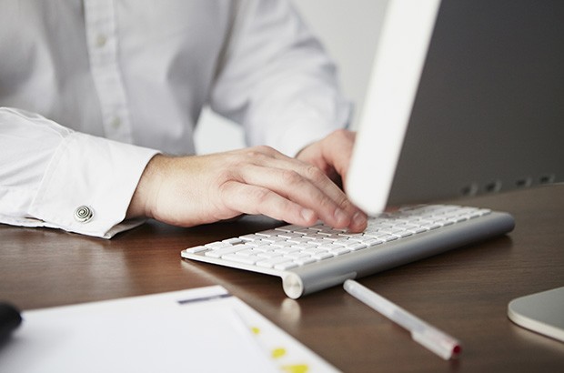 Hands typing on a keyboard. 