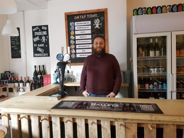 Rhys in the The shop front of the bar