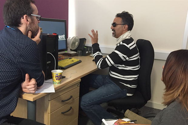 A man sitting at a desk taking part in an accessibility test. 