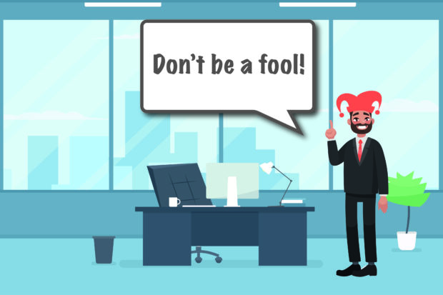 Cartoon office worker dressed as jester with a speech bubble and the words 'Don't be a fool' 