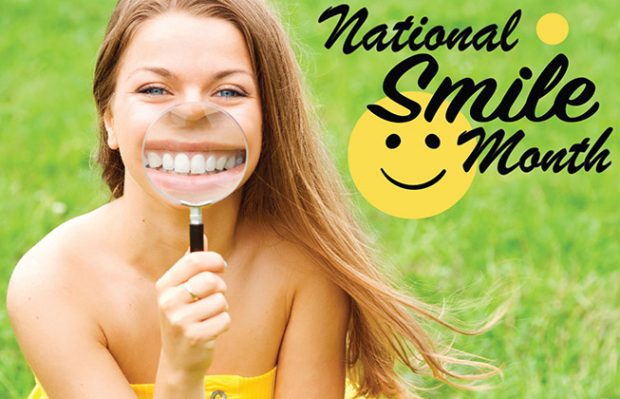 Girl smiling with magnifying glass to her mouth.