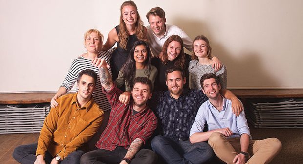 A group of people all smiling at the camera. 