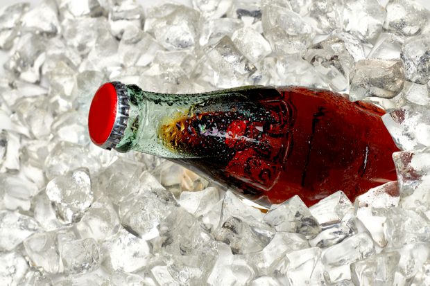 Bottle of cola in crushed ice.