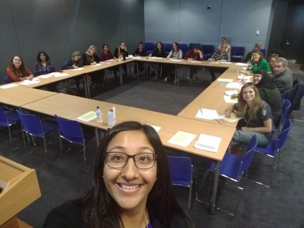 A photo of a group of people in a classroom. 