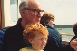 Ben Atkinson-Willes as a young child on a boat with his grandfather.