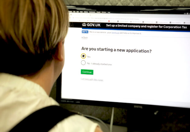 A woman looking at a the set up a limited company and register for corporation tax screen.