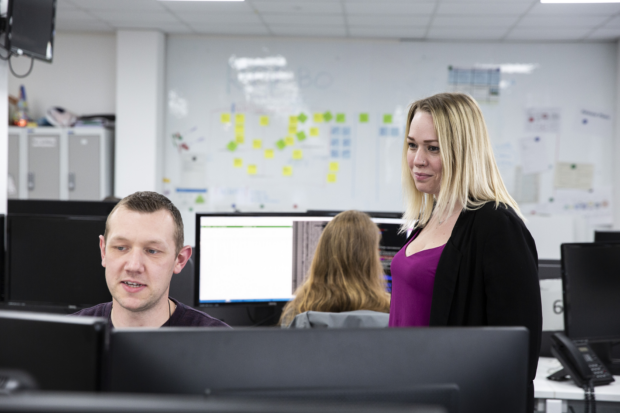 Companies House colleagues at work in front of a computer screen.