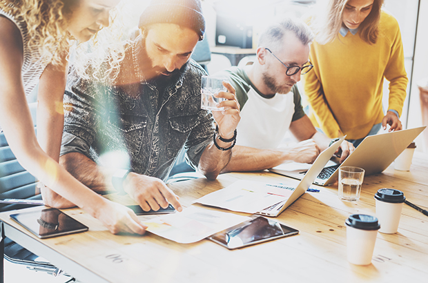 A group of young entrepreneurs working together at a desk