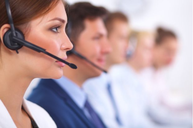 Colleagues taking calls in a call centre.