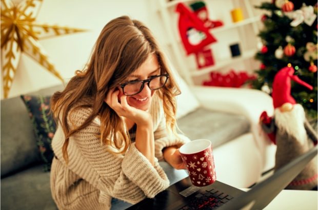 Lady looking at laptop at Christmas time