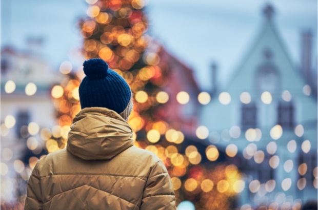 Image of back of a man with festive blurred background