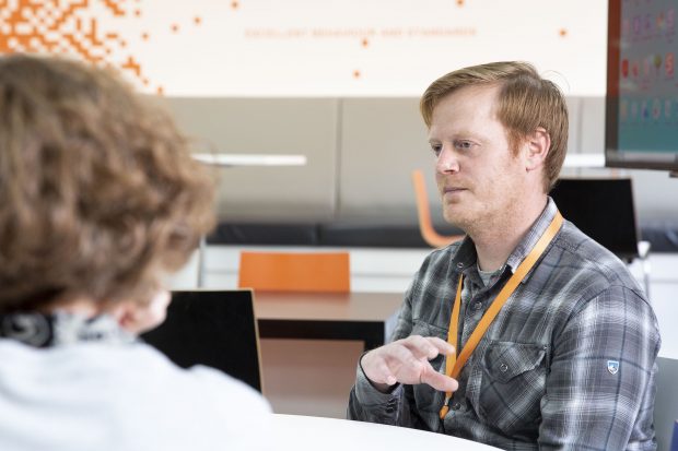 Man speaking to colleague