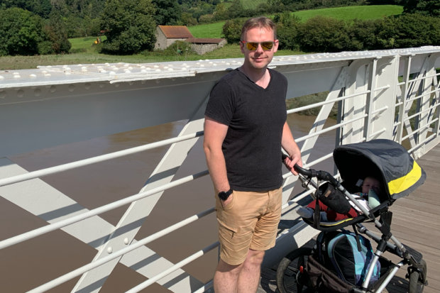 Mike standing on a bridge. 