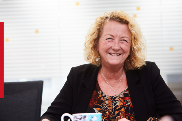 Louise Smyth, Registrar of Companies for England and Wales, smiling in an office environment. 