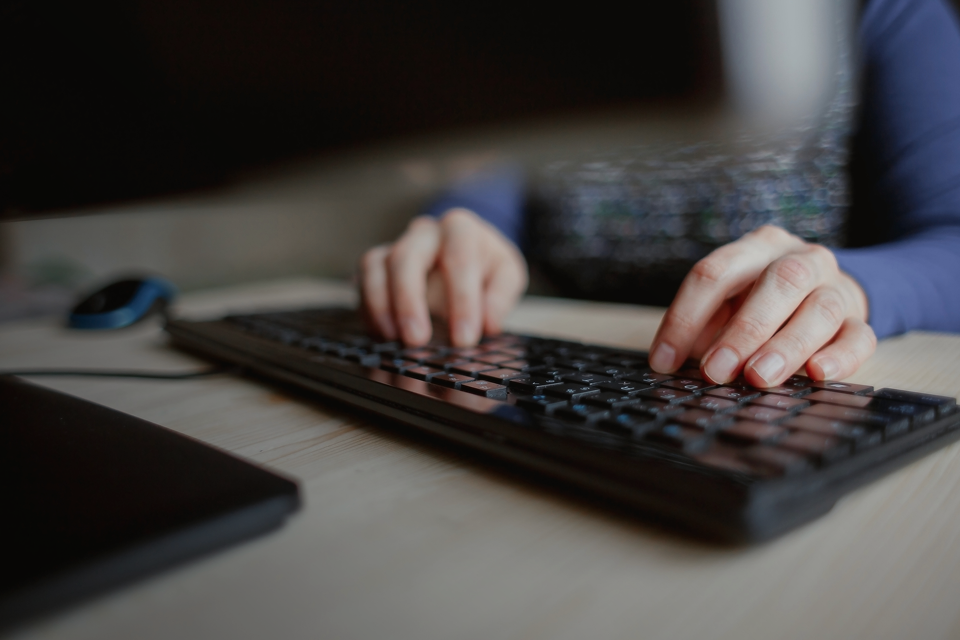 Hands working on a keyboard. 