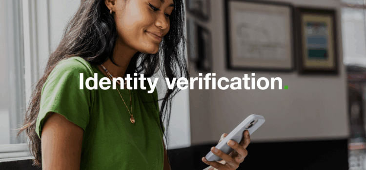 A woman is holding and looking at her mobile phone, with the words 'identity verification' over the top